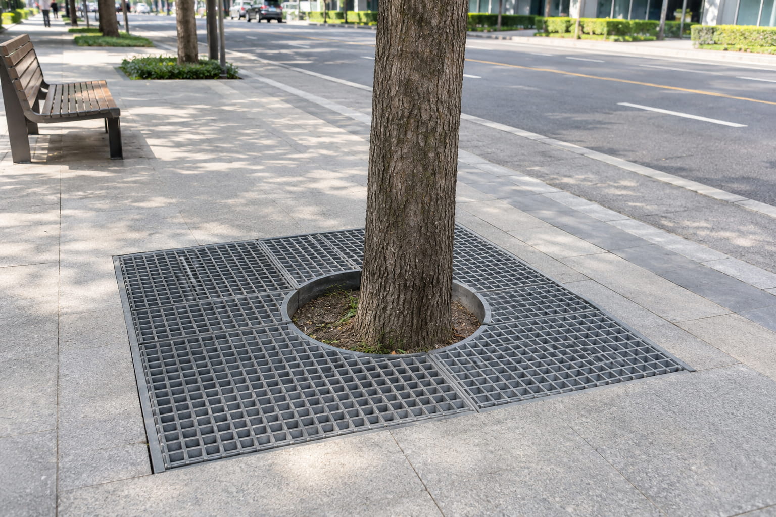 FRP fiberglass tree pit grating installed around a street tree in a paved pedestrian walkway FRP fiberglass tree pit grating installed around a street tree in a paved pedestrian walkway