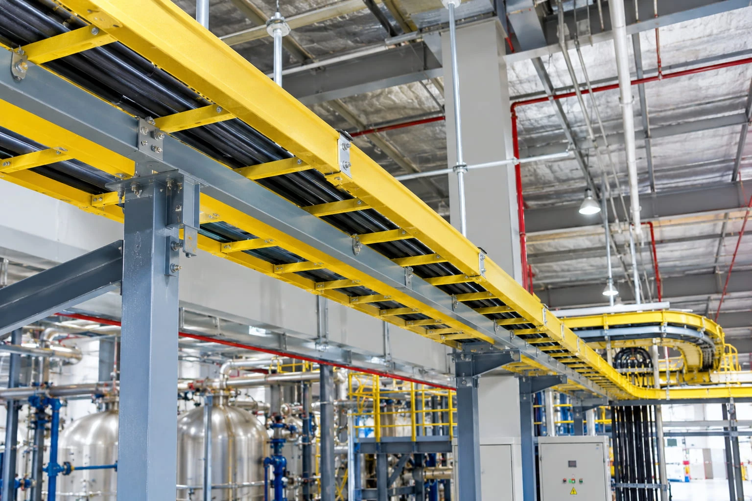 FRP fiberglass cable tray installed on structural supports in an industrial facility FRP fiberglass cable tray installed on structural supports in an industrial facility